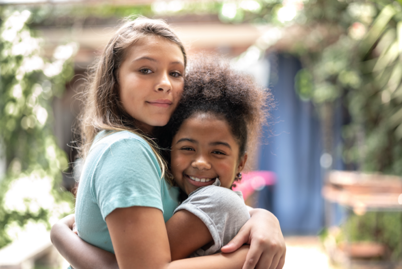 Two Girls Hugging 800x535